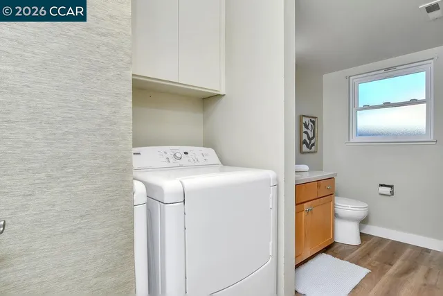 a bathroom with a granite countertop sink mirror and toilet