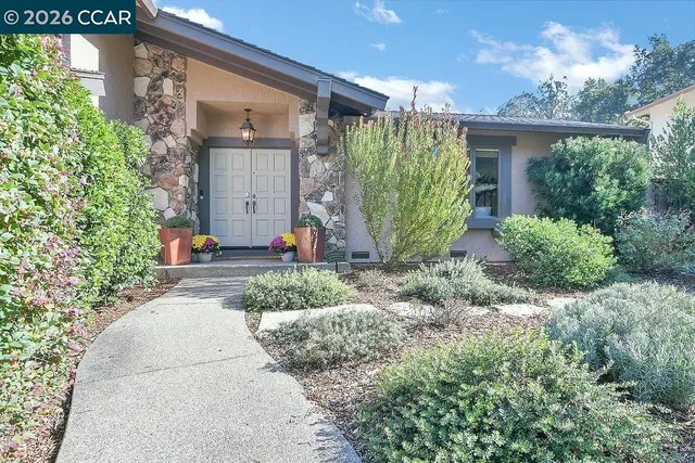 a front view of a house with garden