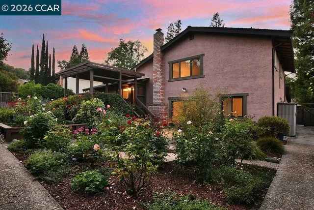 a front view of a house with garden