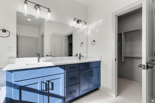 562 West Coyote Rdg Road Grantsville, UT 84029 - Photo 20 of 27 Dual vanity with a white countertop and blue cabinetry