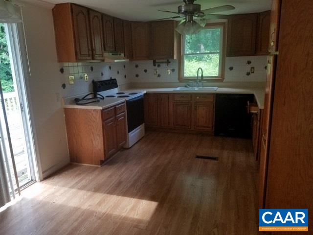 620 Clarks Tract Keswick, VA 22947 - Photo 8 of 21 a kitchen with stainless steel appliances granite countertop a sink a stove a refrigerator cabinets and a window