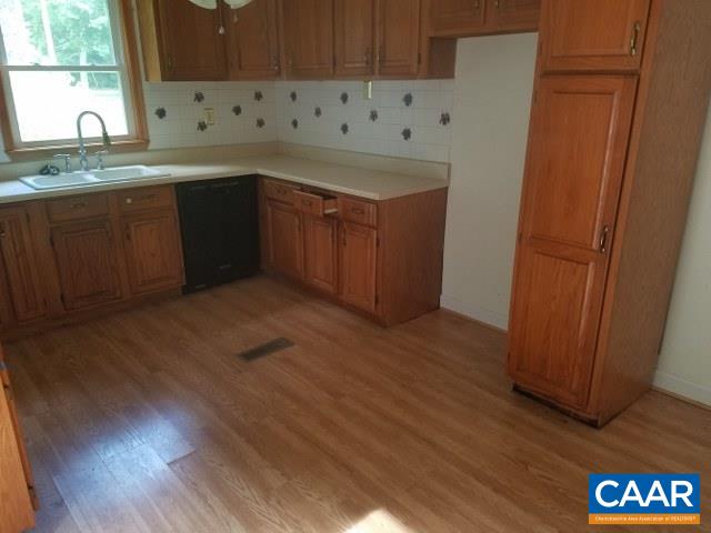 620 Clarks Tract Keswick, VA 22947 - Photo 9 of 21 a kitchen with granite countertop a sink and a wooden cabinets