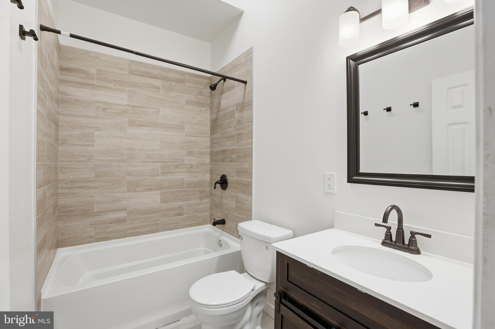 1912 9th Street Northwest, Unit 1 Washington, DC 20001 - Photo 10 of 18 a bathroom with a sink toilet vanity and shower