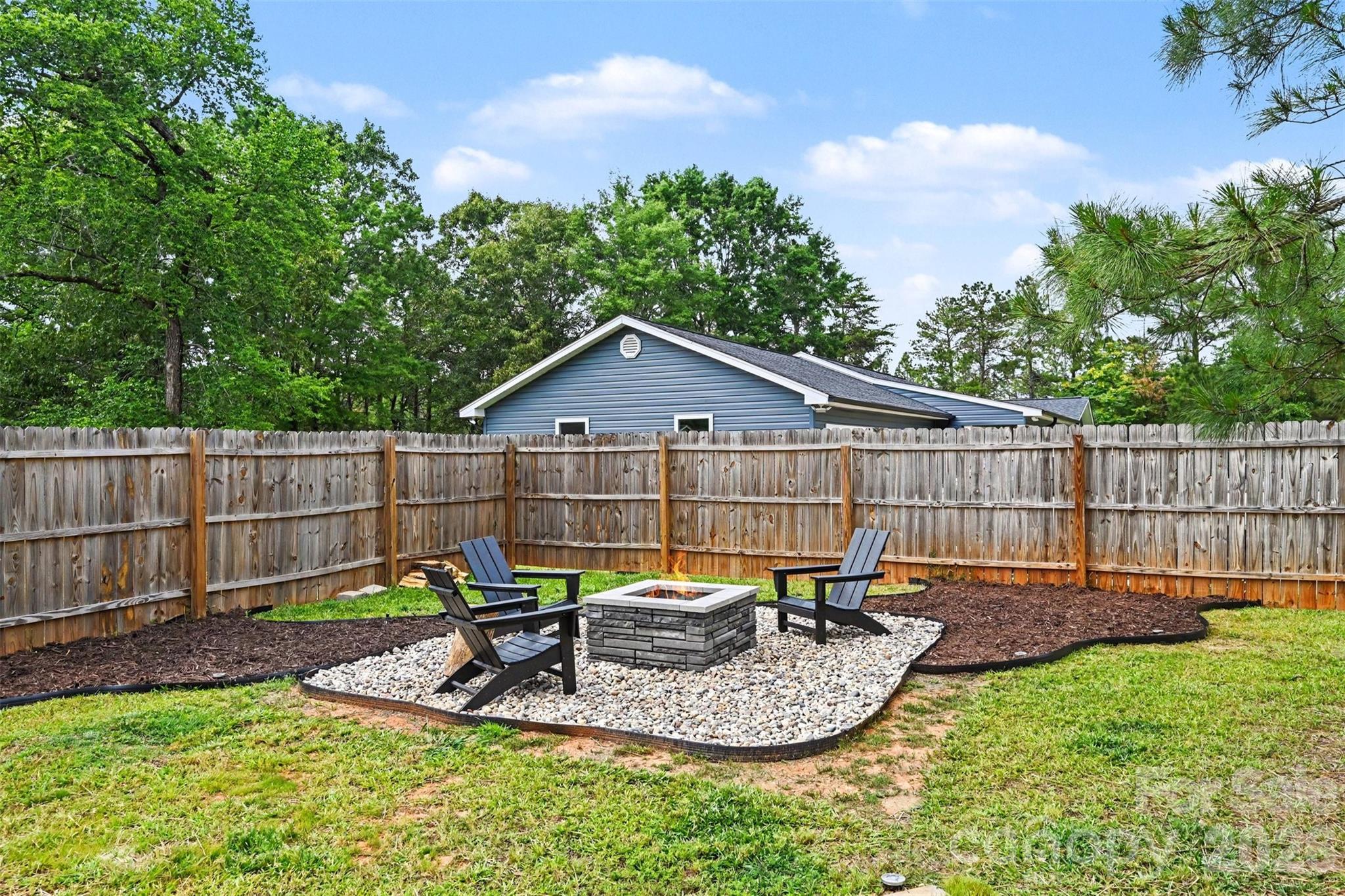 31 Ridgecrest Avenue Peachland, NC 28133 - Photo 11 of 30 a backyard of a house with table and chairs