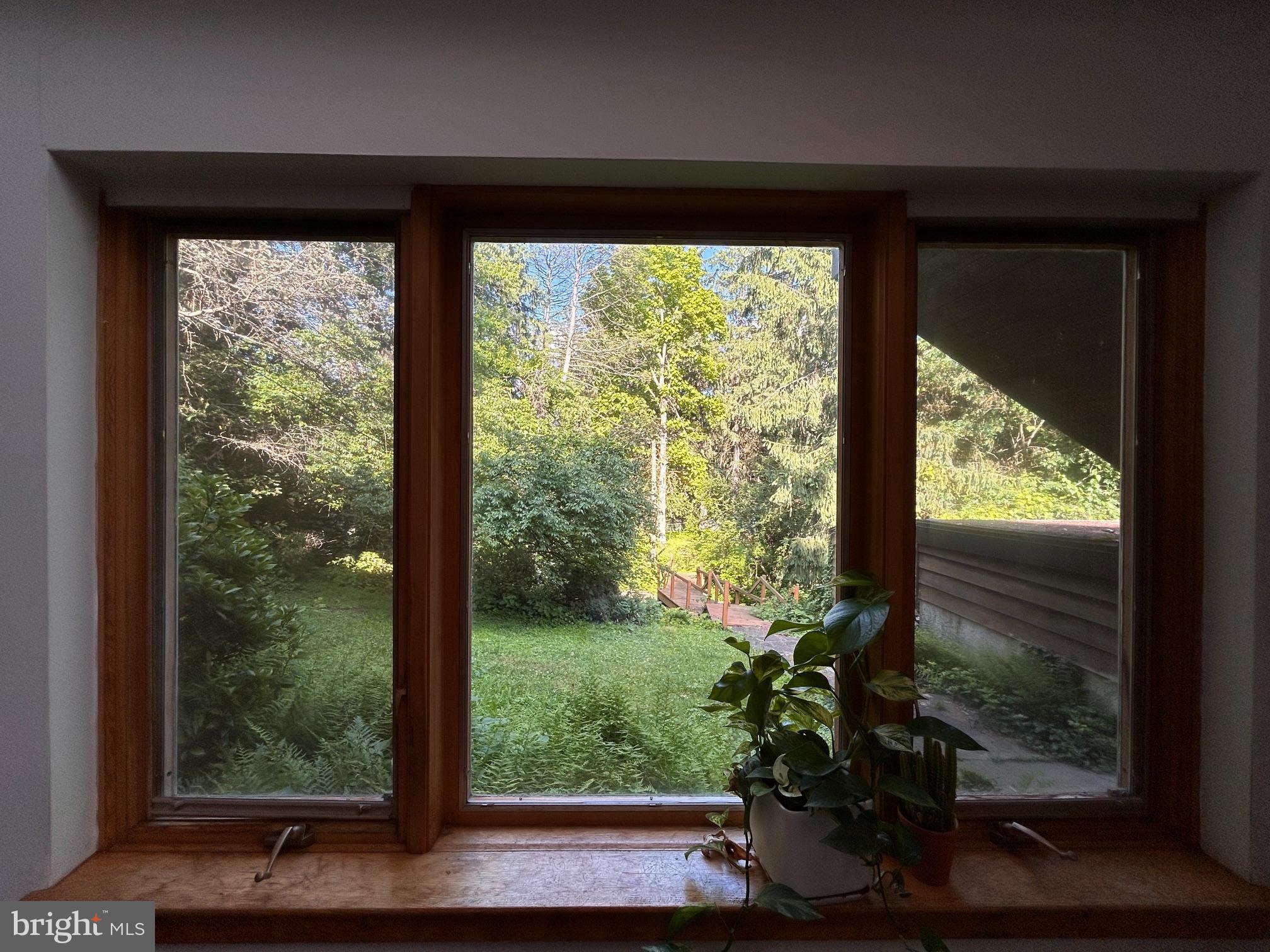 8204 Brookside Road Elkins Park, PA 19027 - Photo 12 of 20 a view of a room with a large window and wooden floor