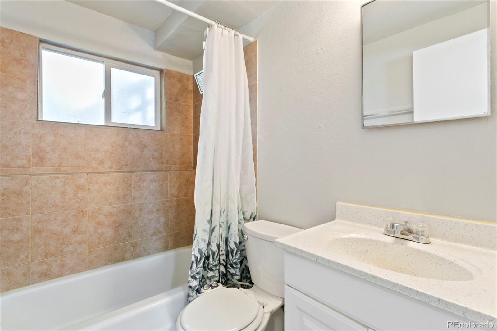 330 Vehr Drive Colorado Springs, CO 80916 - Photo 14 of 17 a bathroom with a granite countertop sink toilet and shower