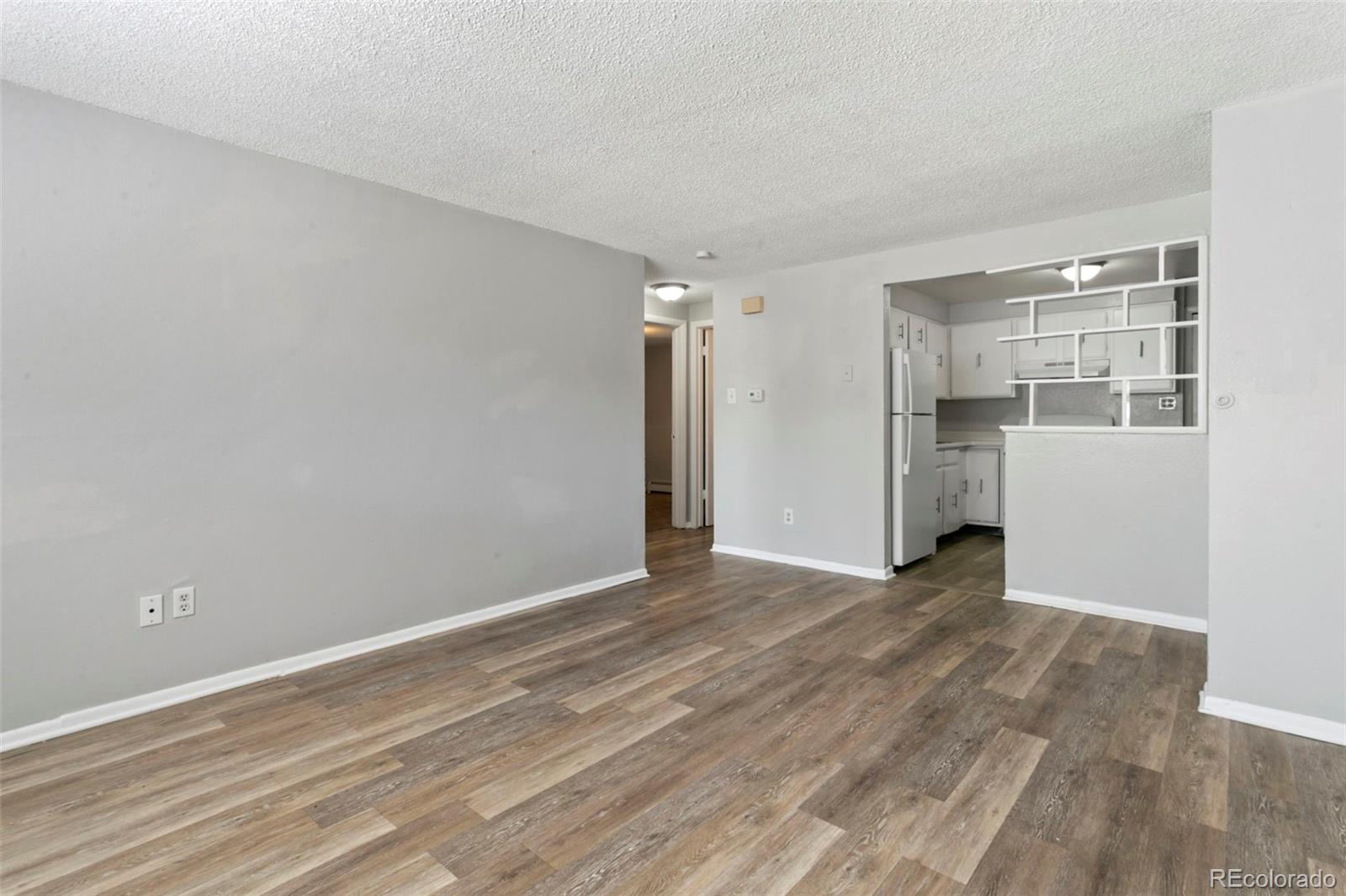 330 Vehr Drive Colorado Springs, CO 80916 - Photo 3 of 17 a view of an empty room with wooden floor and a window