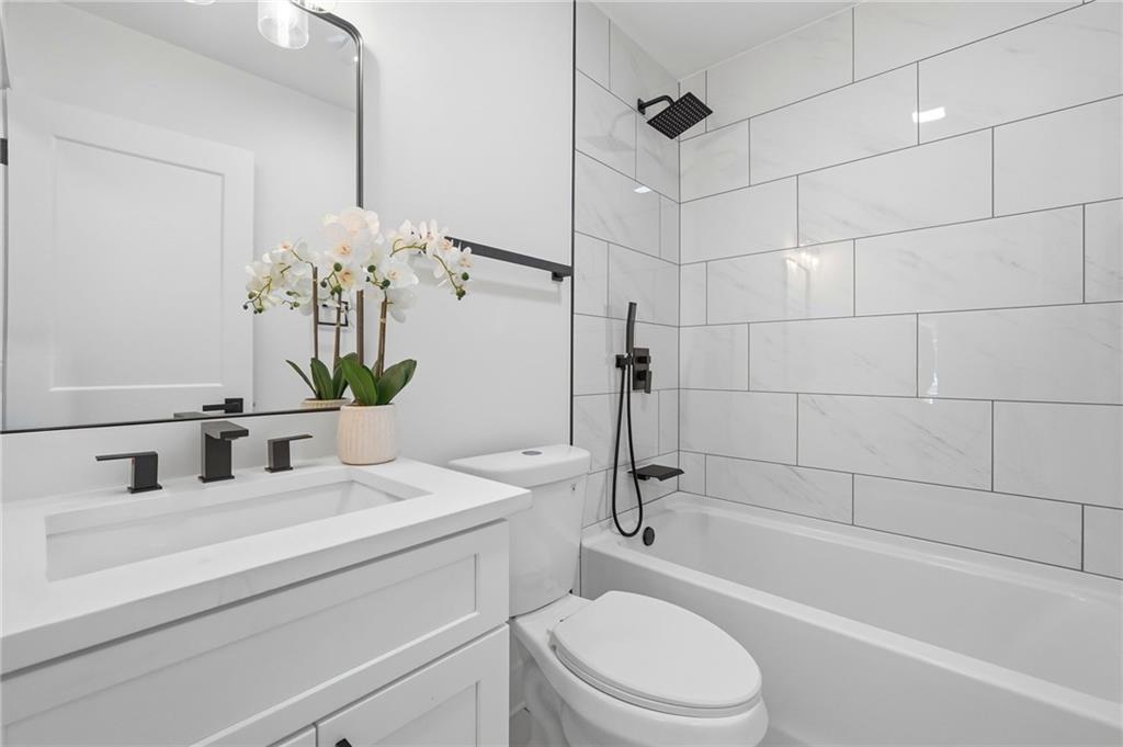 2118 Glendale Drive Decatur, GA 30032 - Photo 14 of 23 a bathroom with a sink a toilet and bathtub