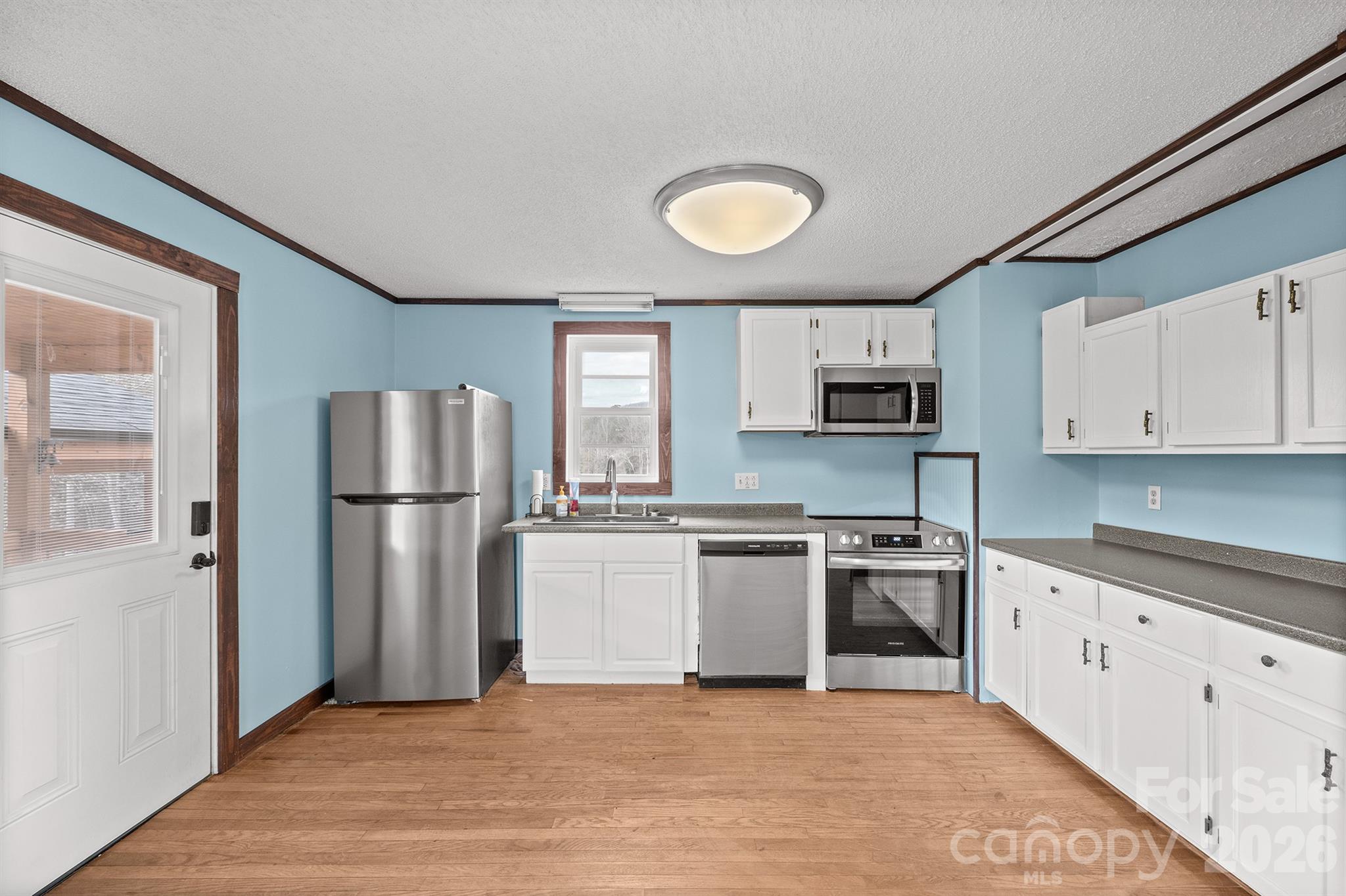 7400 Corn Hill Road Connelly Springs, NC 28612 - Photo 5 of 41 a kitchen with stainless steel appliances granite countertop a refrigerator sink and stove