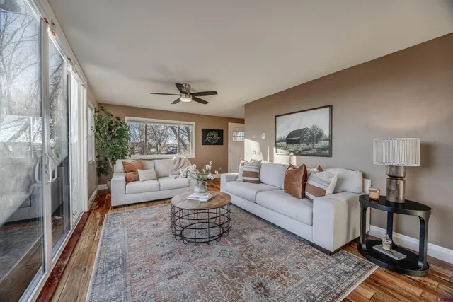 a living room with furniture and a large window