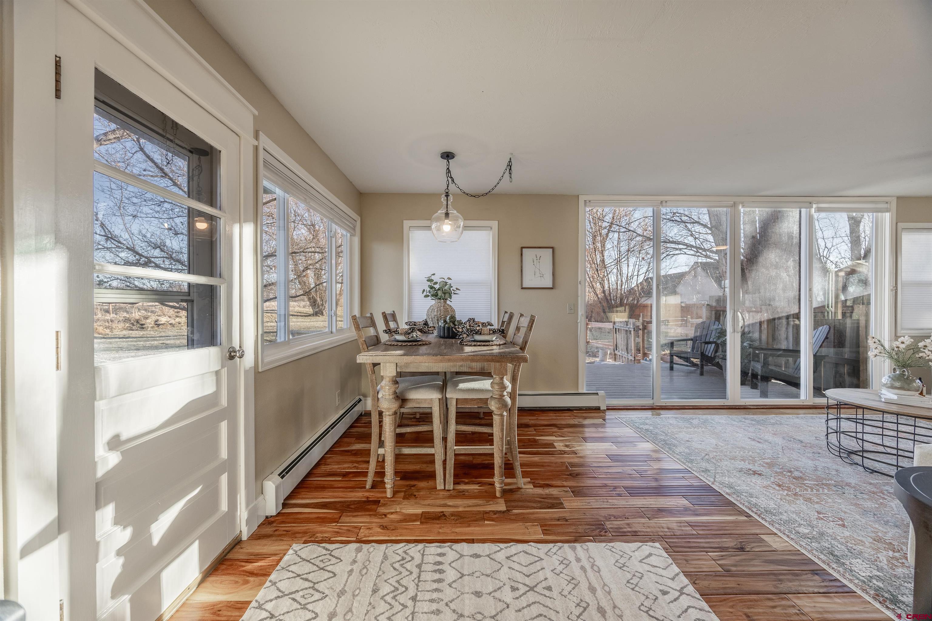 15214 6125th Road Montrose, CO 81403 - Photo 19 of 45 a dining room with wooden floor and a rug