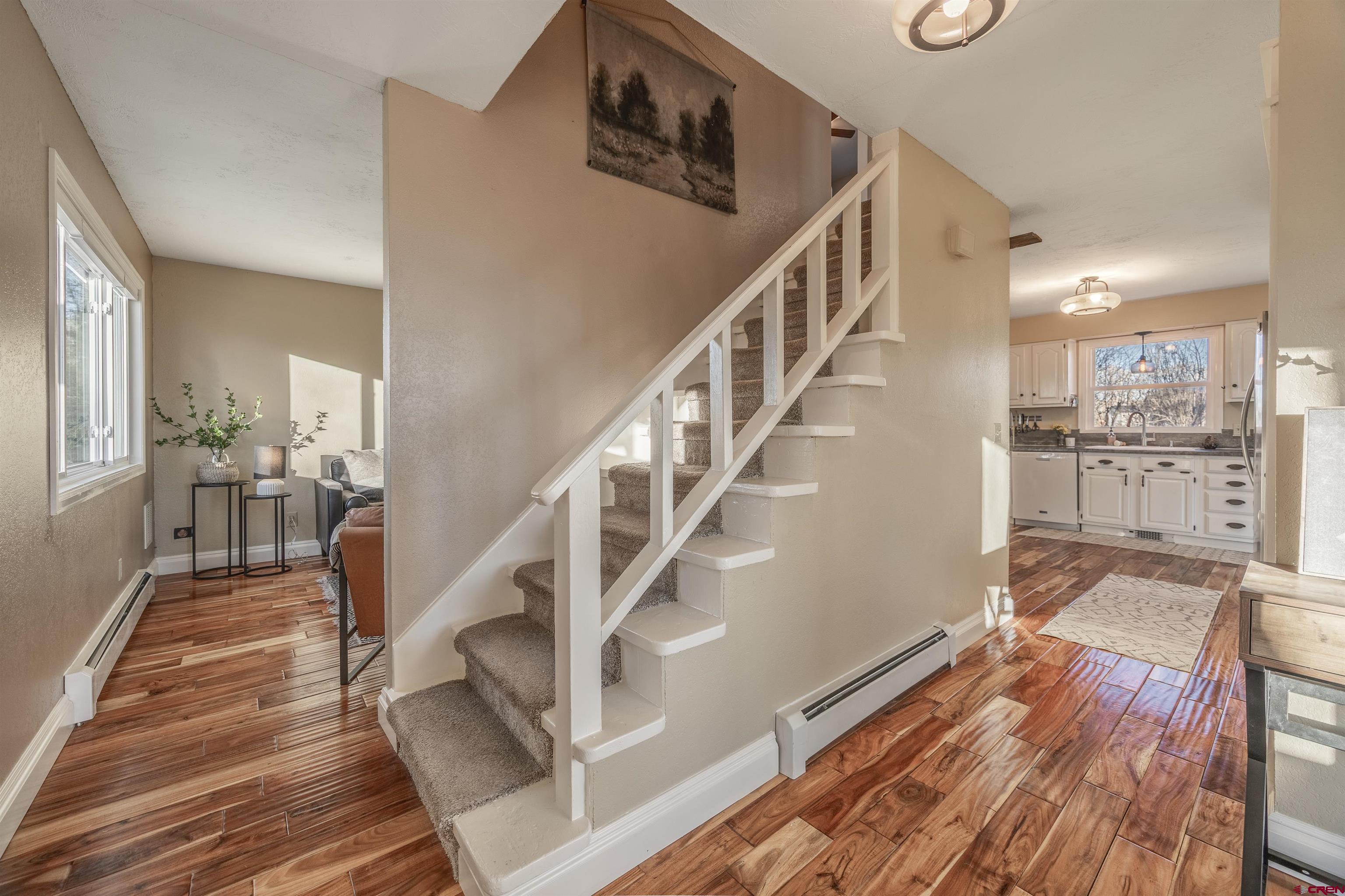 15214 6125th Road Montrose, CO 81403 - Photo 22 of 45 a view of a hallway with wooden floor and staircase