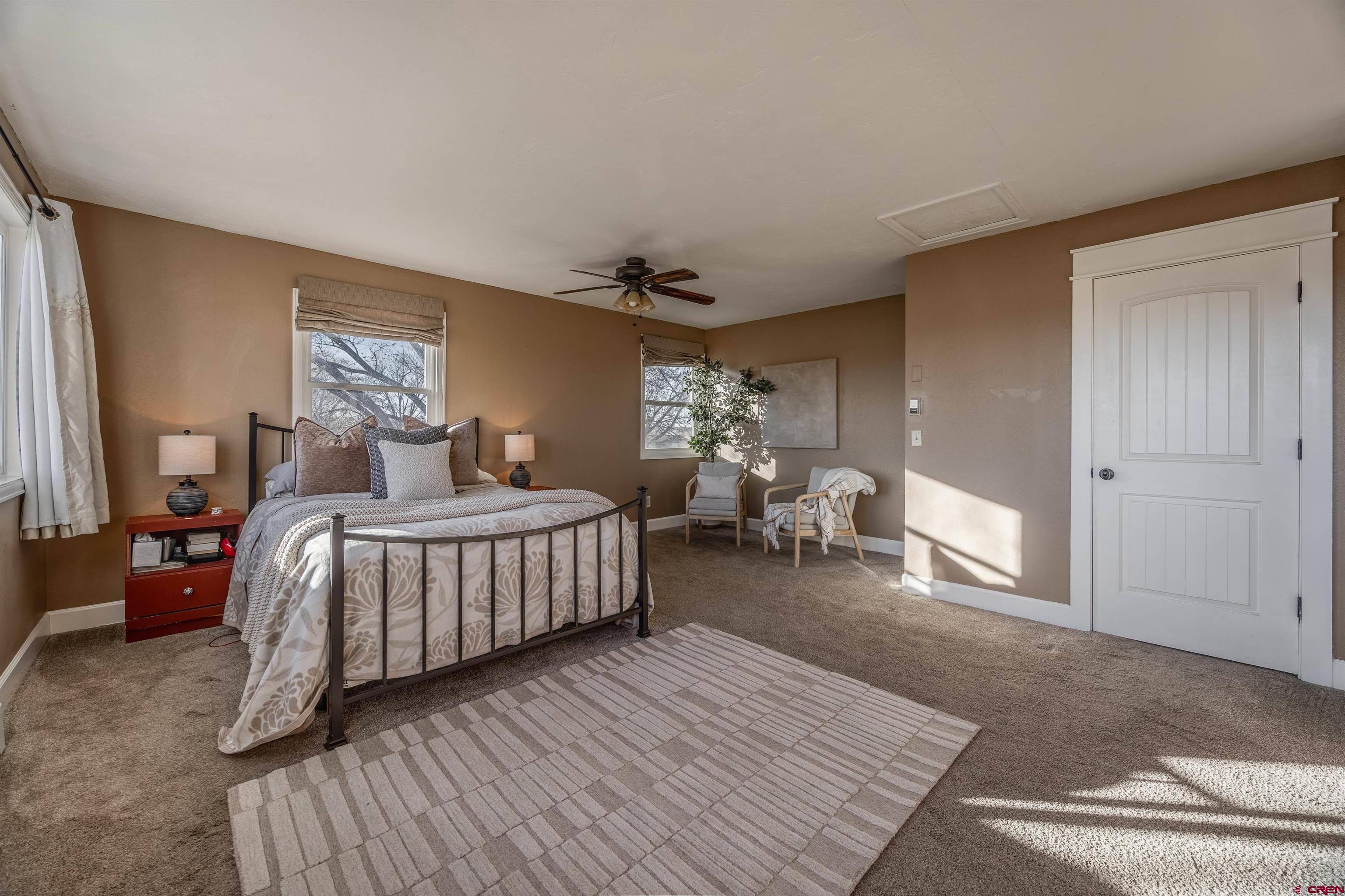 15214 6125th Road Montrose, CO 81403 - Photo 23 of 45 a bedroom with a bed and wooden floor
