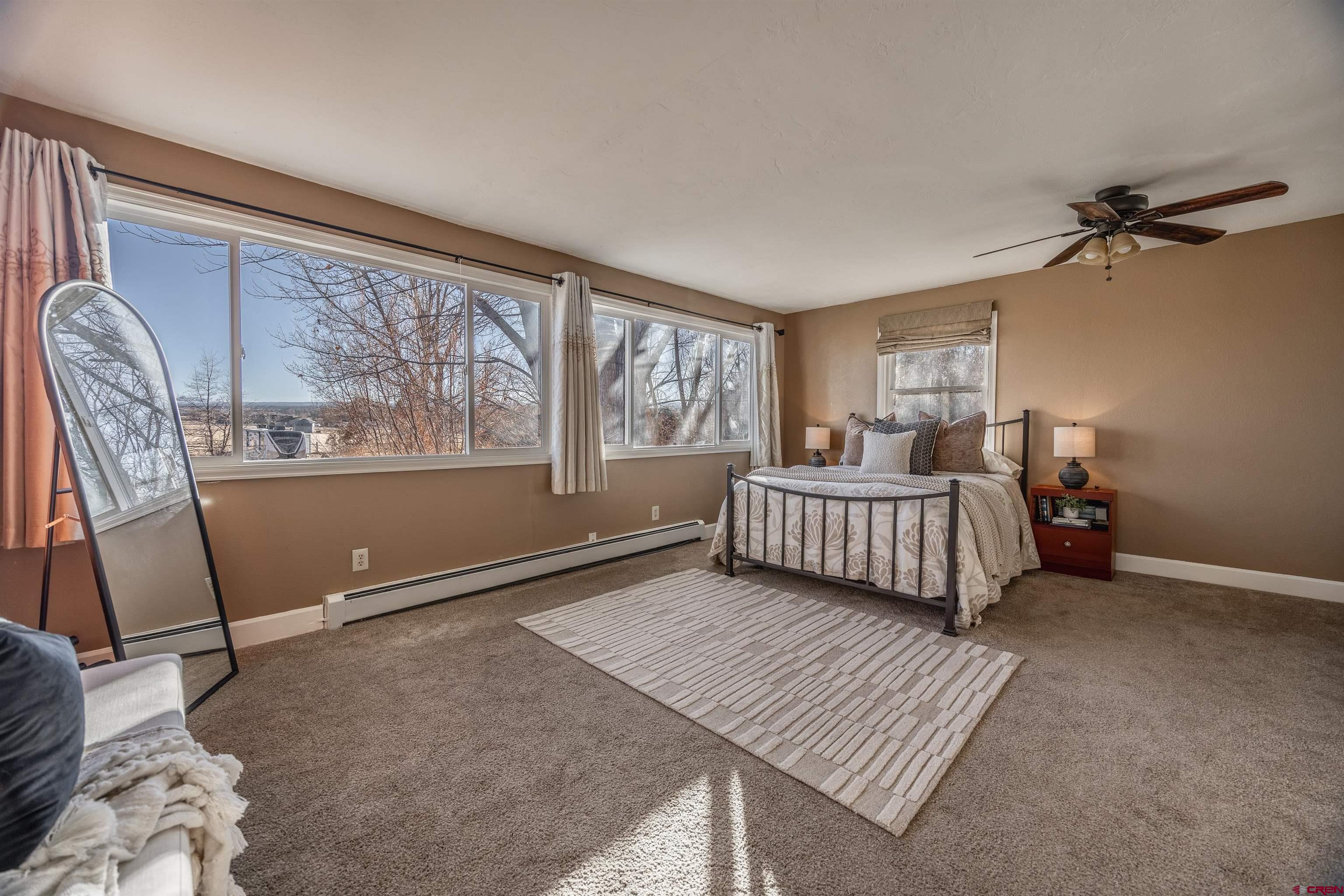 15214 6125th Road Montrose, CO 81403 - Photo 24 of 45 a bedroom with a bed and wooden floor