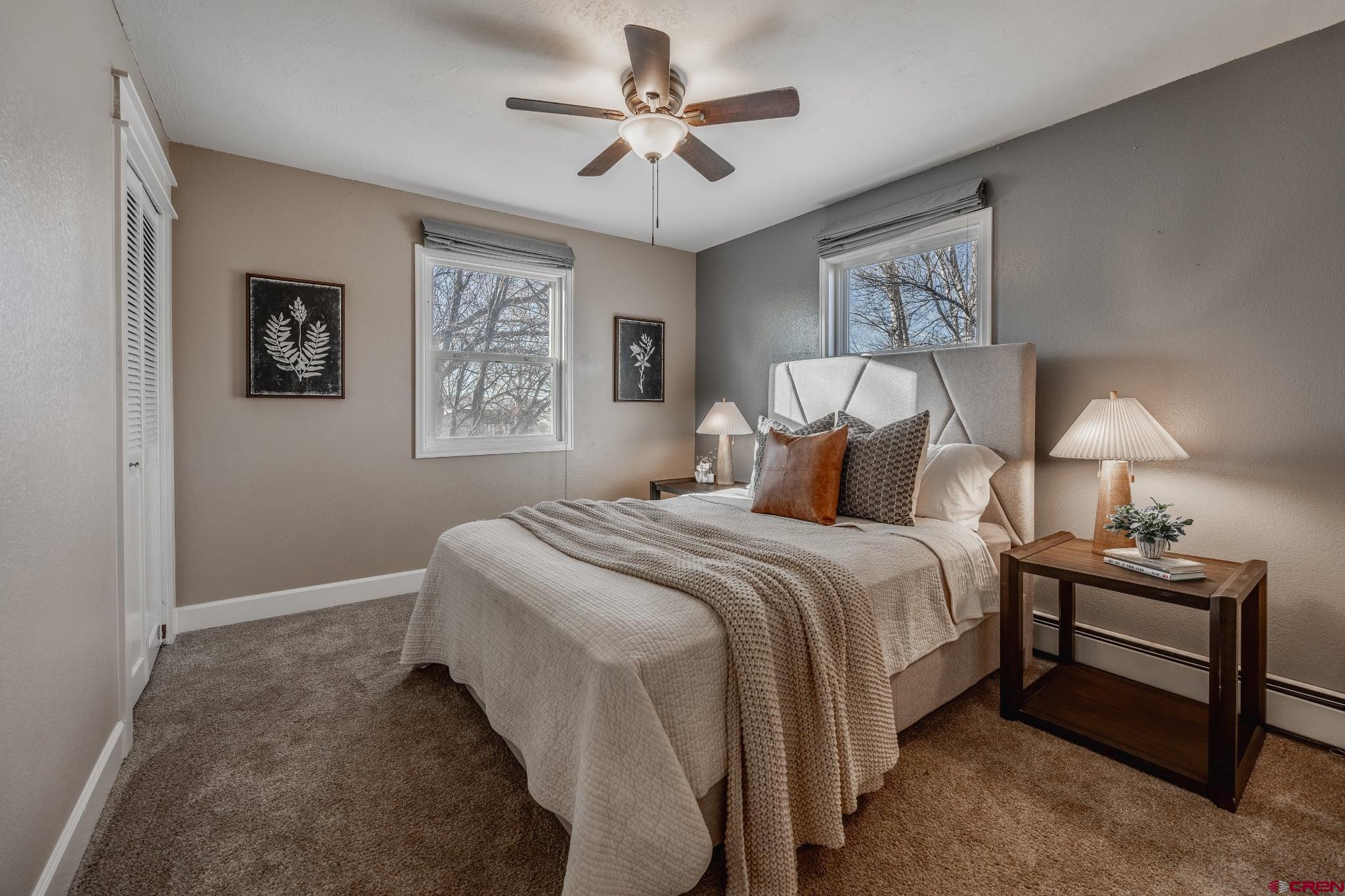 15214 6125th Road Montrose, CO 81403 - Photo 29 of 45 a bedroom with a bed and a chandelier