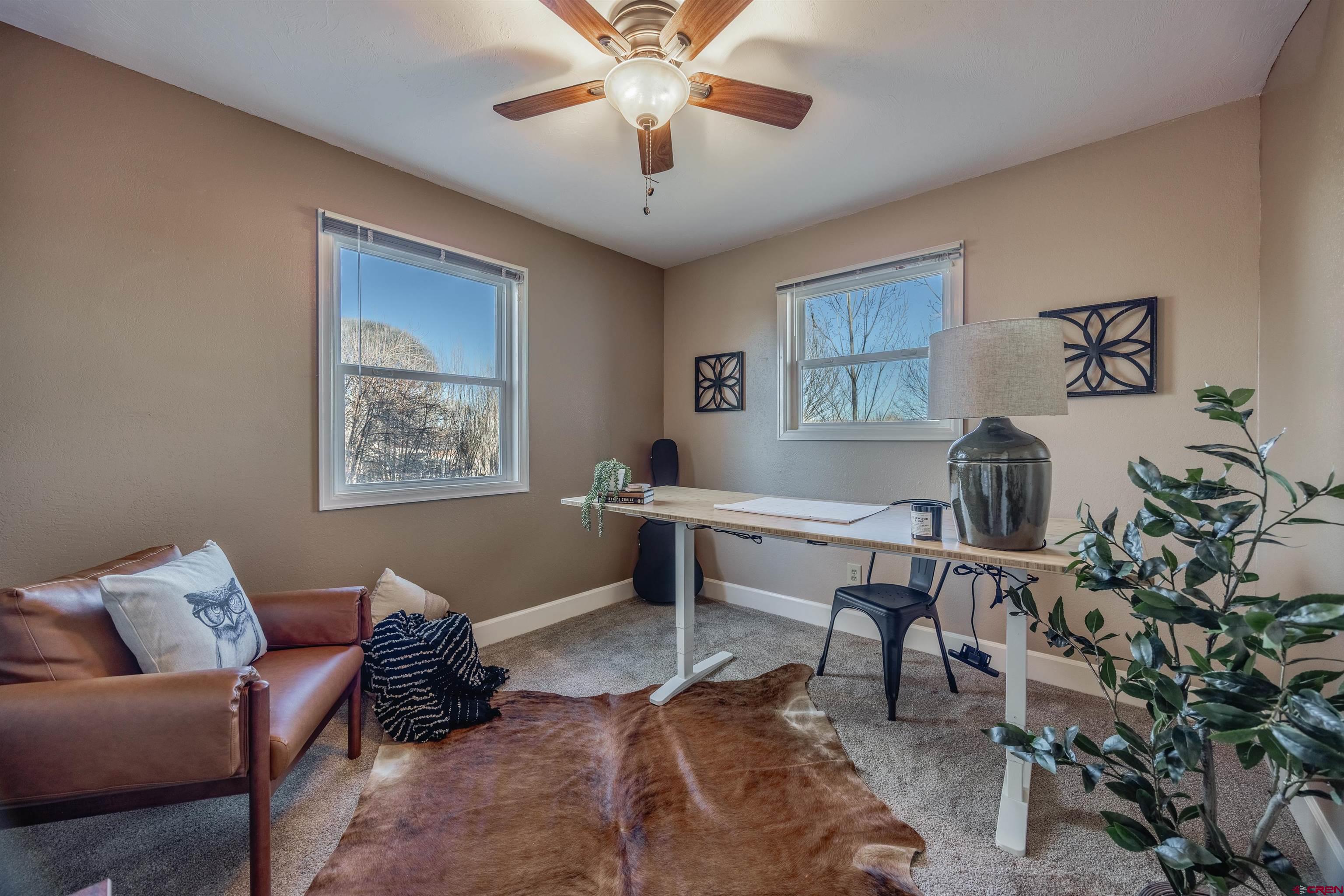15214 6125th Road Montrose, CO 81403 - Photo 30 of 45 a living room with furniture and a chandelier