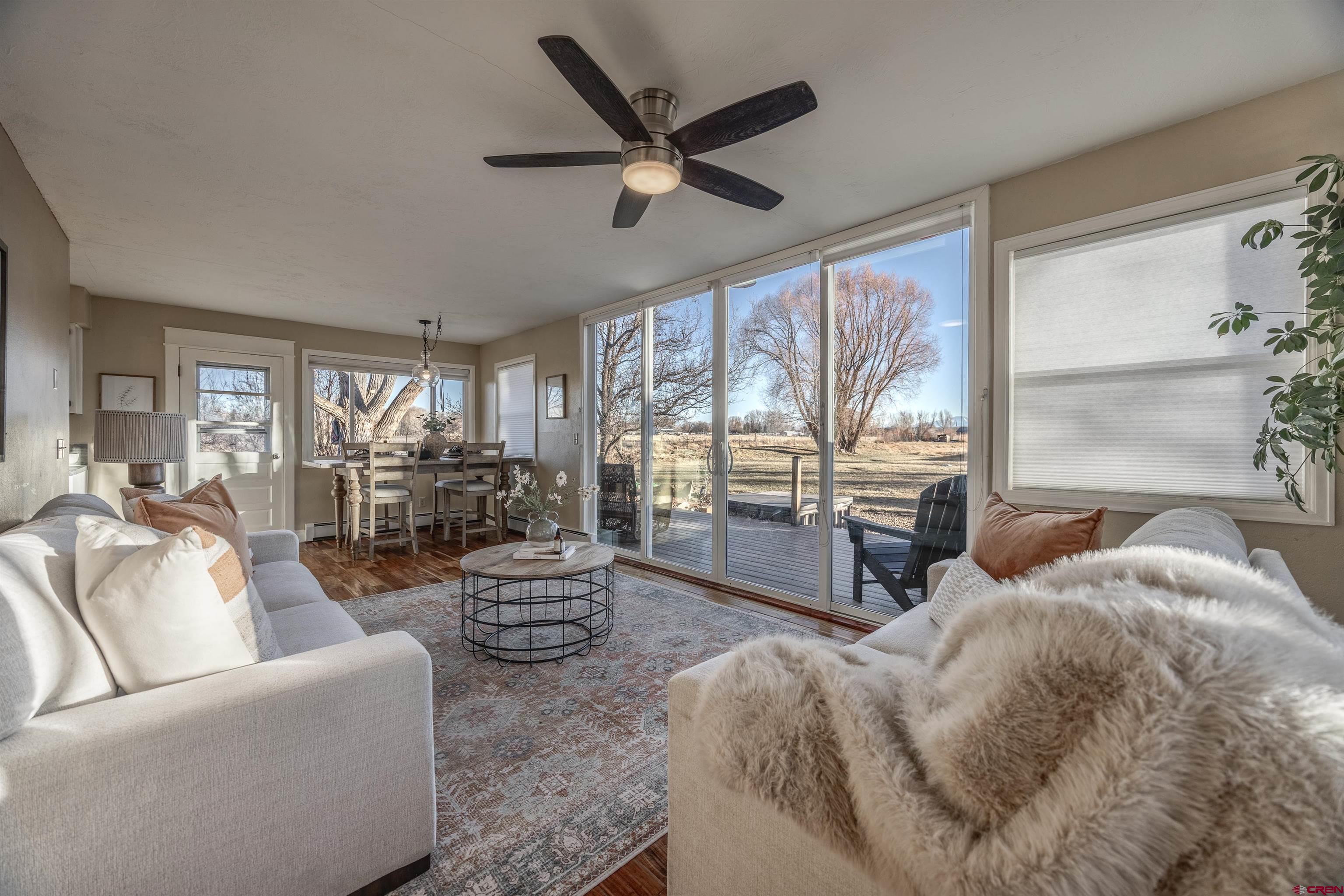 15214 6125th Road Montrose, CO 81403 - Photo 10 of 45 a living room with furniture and a large window with wooden floor