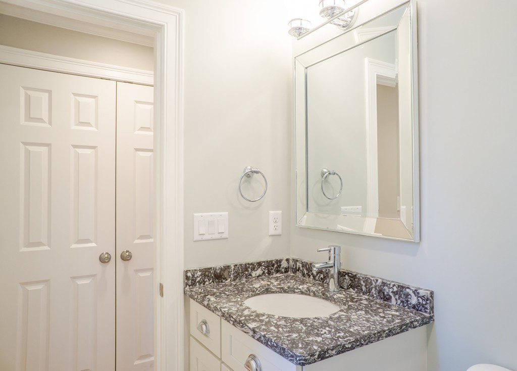 305 Old Pickard Road Concord, MA 01742 - Photo 11 of 16 a bathroom with a granite countertop sink and a mirror