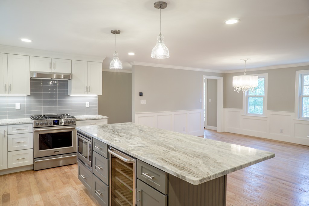 305 Old Pickard Road Concord, MA 01742 - Photo 3 of 16 a kitchen with granite countertop a sink cabinets and wooden floor