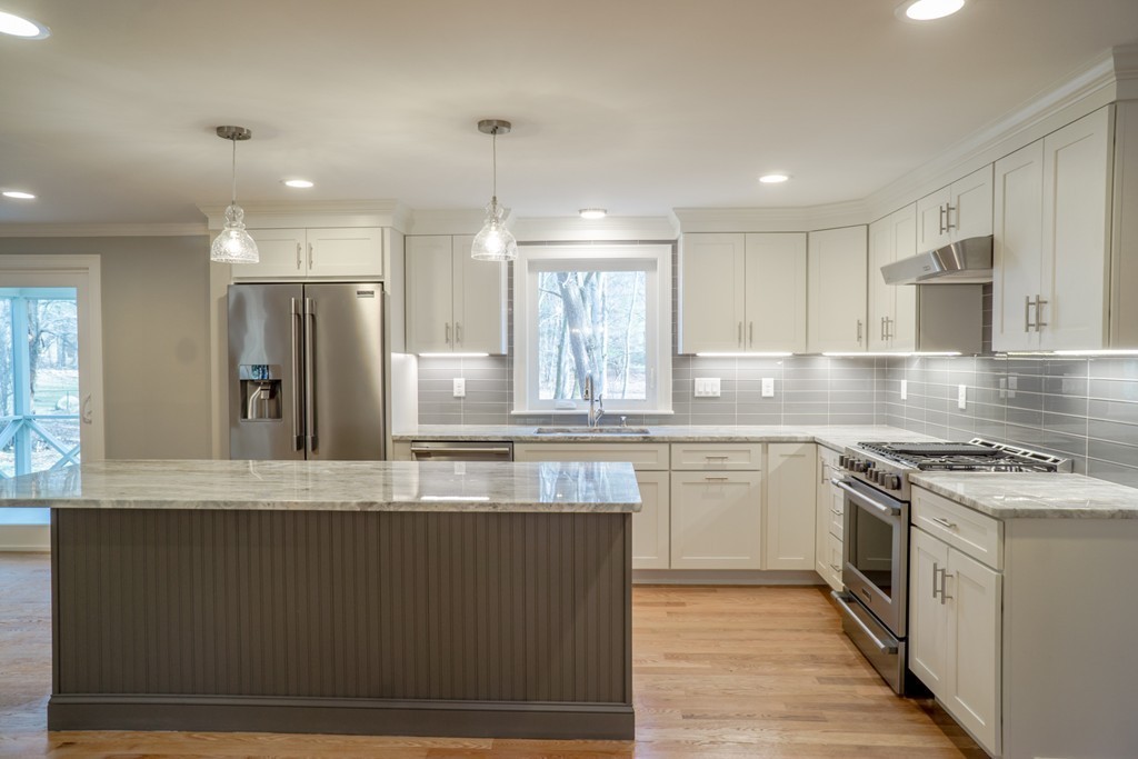 305 Old Pickard Road Concord, MA 01742 - Photo 4 of 16 a kitchen with stainless steel appliances granite countertop a stove a sink and a refrigerator