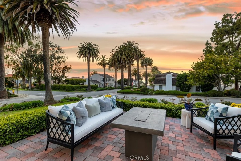 a view of a patio with couches and a fire pit