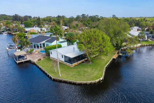 a view of a lake with couches chairs and a fire pit