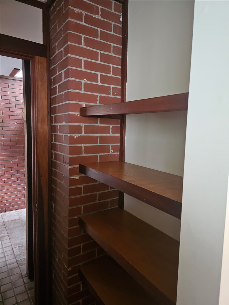 114 Houston Street Clemson, SC 29631 - Photo 10 of 19 Rich wood shelving integrated alongside an exposed brick column creates a warm architectural accent.