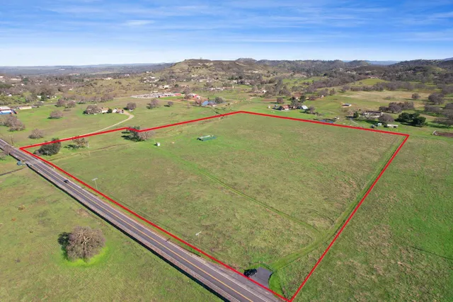 a view of a pool with a table and chairs