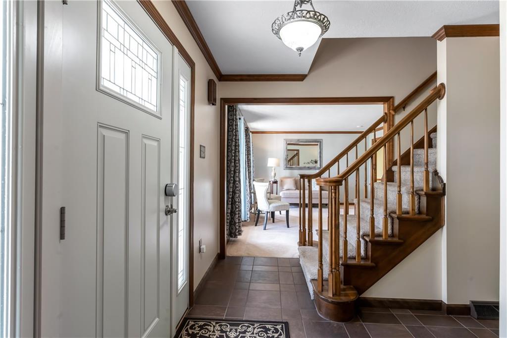 10514 Meinert Road Wexford, PA 15090 - Photo 3 of 20 Spacious entry with access to the 2 car integral garage that offers shelving and cabinetry. New tile flooring as well as new front door with keyless entry.