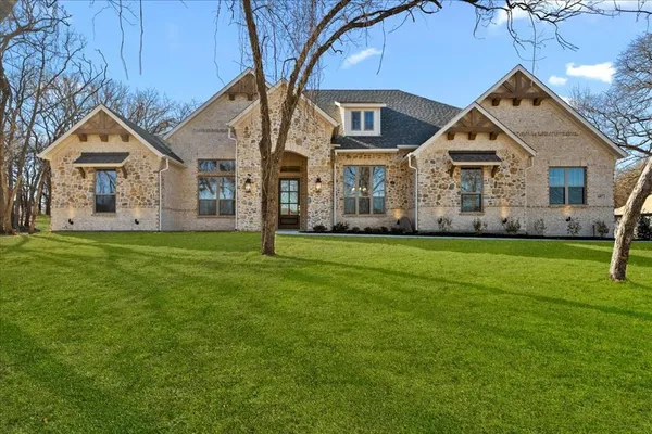 a front view of house with yard and green space