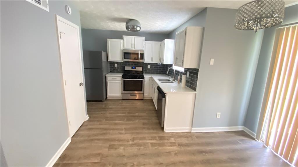 3791 Reston Lane Decatur, GA 30034 - Photo 5 of 20 a kitchen with cabinets and wooden floor