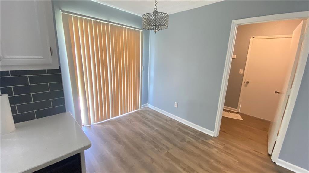3791 Reston Lane Decatur, GA 30034 - Photo 7 of 20 an empty room with wooden floor and windows