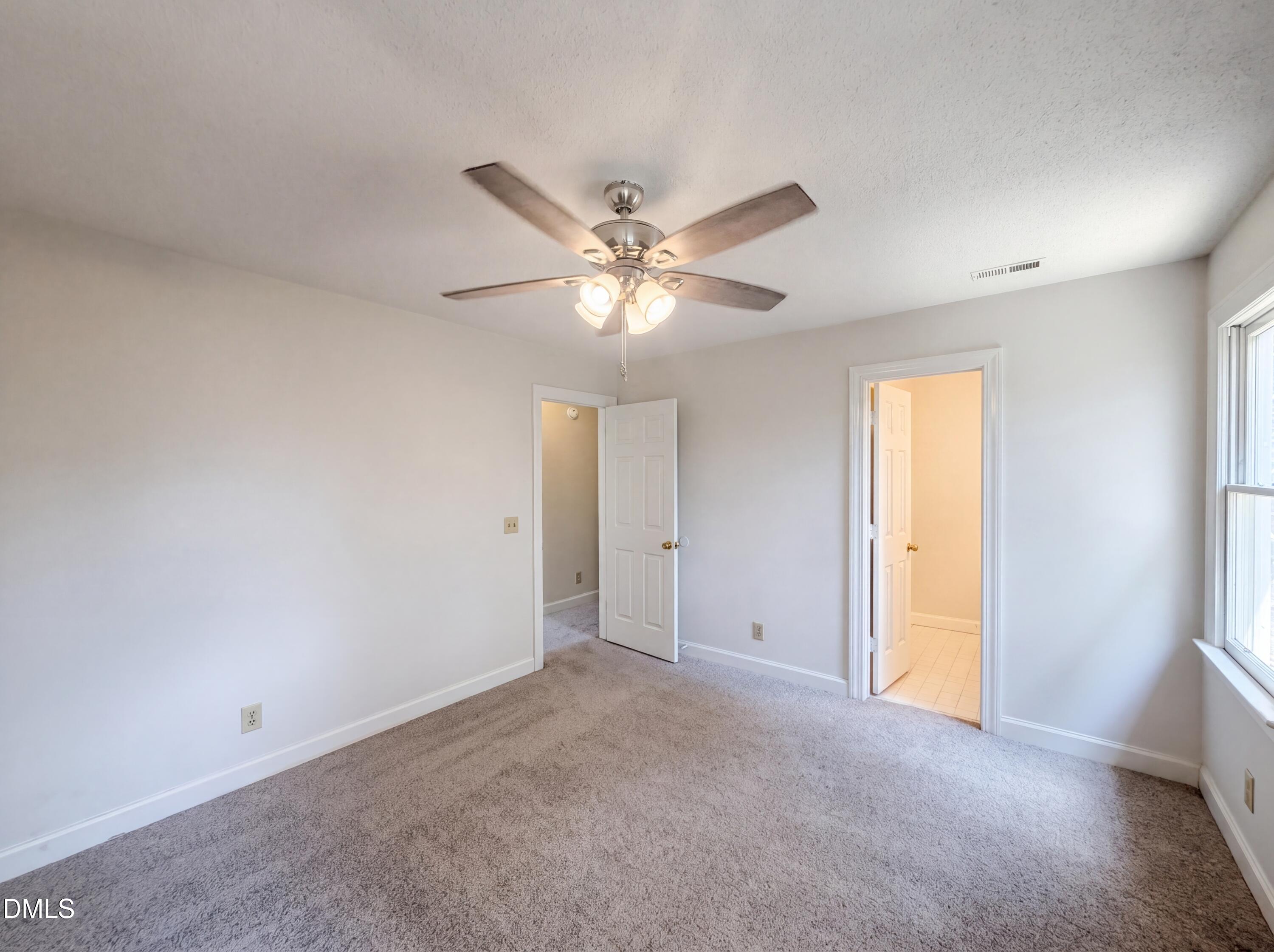 3921 Iron Horse Road Raleigh, NC 27616 - Photo 9 of 20 a view of an empty room with a ceiling fan and window