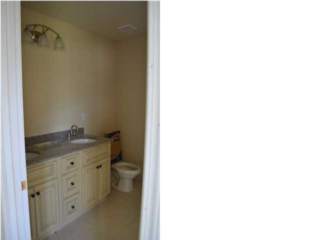 5254 Moore Loop Crestview, FL 32536 - Photo 7 of 13 a bathroom with a granite countertop toilet and sink