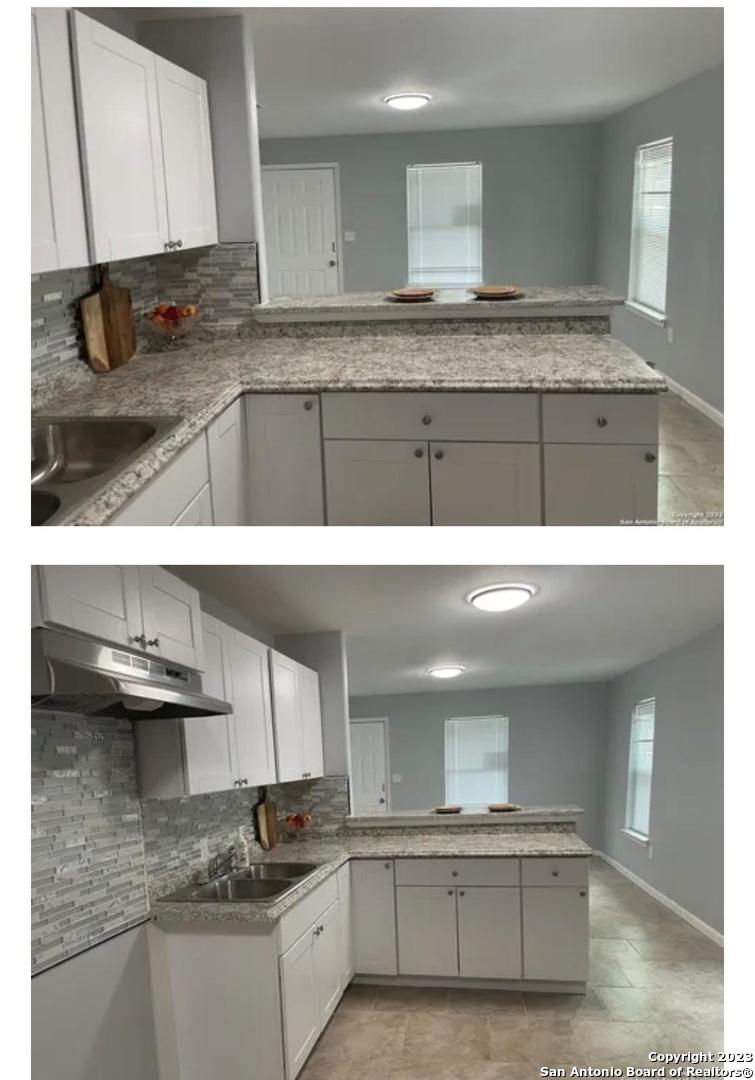 a kitchen with kitchen island granite countertop a sink a stove and cabinets