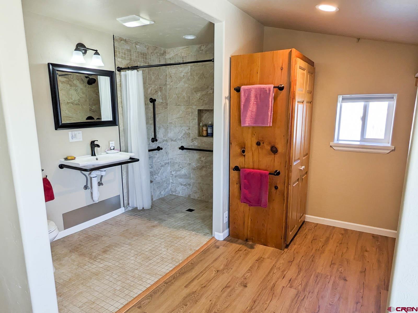 1244 Ash Mesa Road Delta, CO 81416 - Photo 15 of 35 a bathroom with a sink mirror and shower