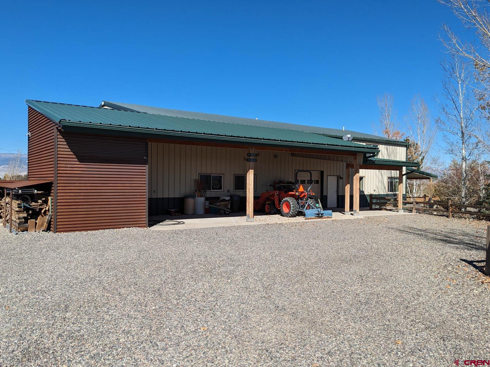 1244 Ash Mesa Road Delta, CO 81416 - Photo 33 of 35 a view of a house with patio and a yard