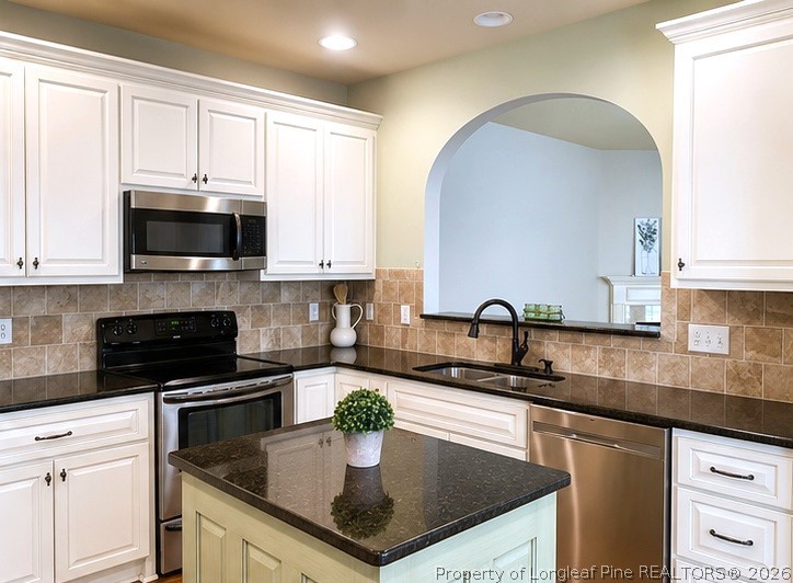 175 Pine Hawk Drive Spring Lake, NC 28390 - Photo 10 of 43 a kitchen with granite countertop a sink a stove and cabinets