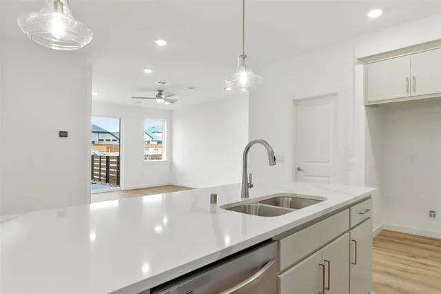 a view of a kitchen with a sink and chandelier