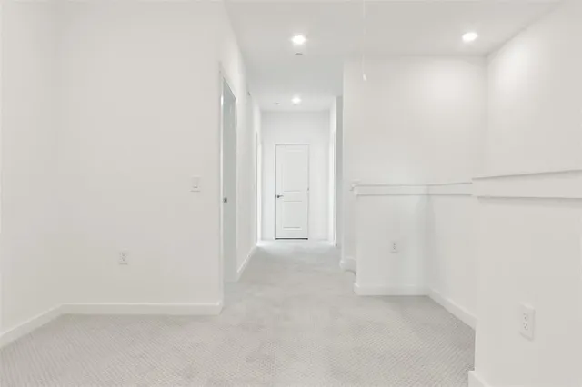 an empty room with a window and a ceiling fan