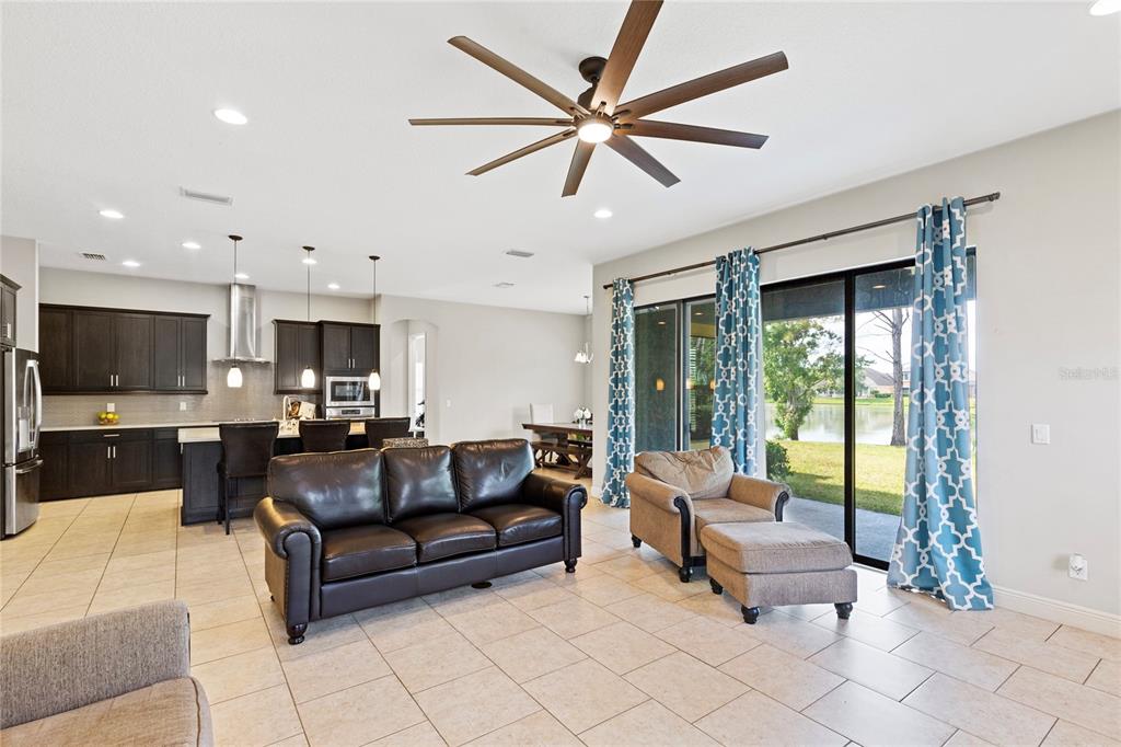 31976 Watoga Loop Wesley Chapel, FL 33543 - Photo 11 of 47 a living room with furniture a flat screen tv and a large window