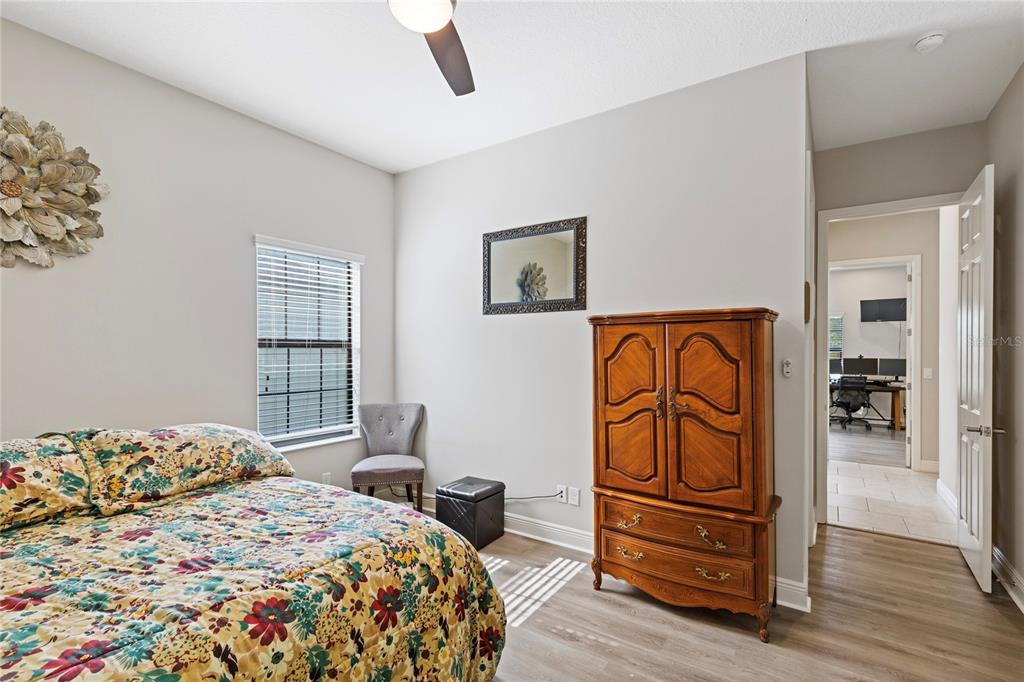 31976 Watoga Loop Wesley Chapel, FL 33543 - Photo 18 of 47 a bedroom with a bed and wooden floor