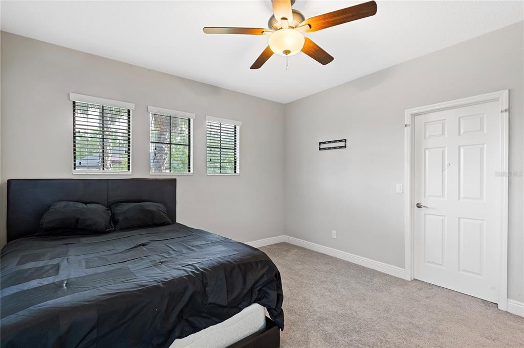 31976 Watoga Loop Wesley Chapel, FL 33543 - Photo 32 of 47 a bedroom with a bed and wooden floor