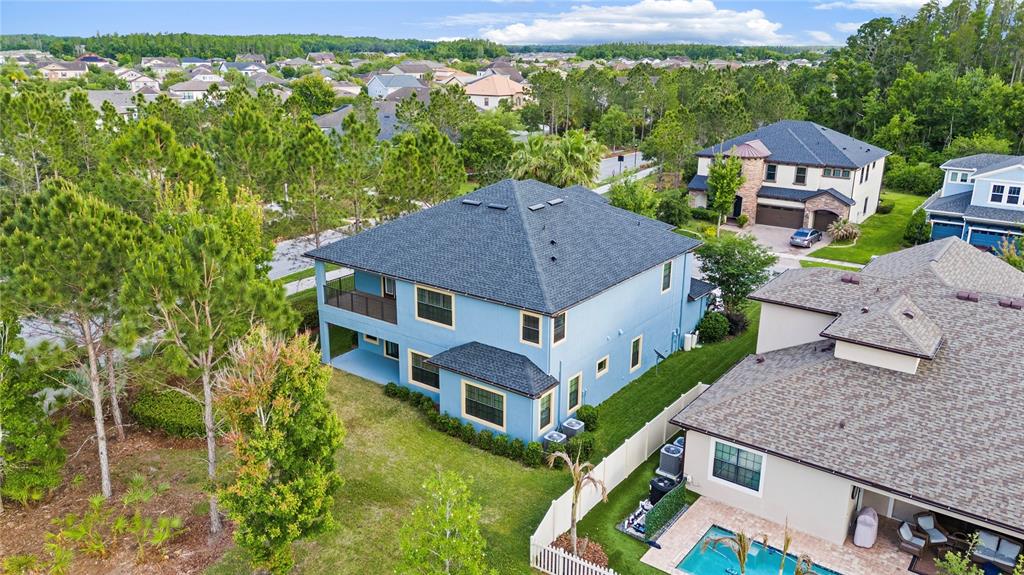 31976 Watoga Loop Wesley Chapel, FL 33543 - Photo 44 of 47 an aerial view of a house with a big yard and large trees
