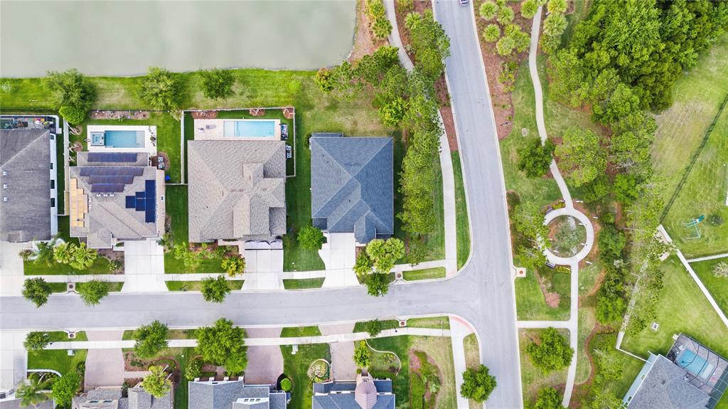 31976 Watoga Loop Wesley Chapel, FL 33543 - Photo 46 of 47 an aerial view of a residential apartment building with a yard and plants