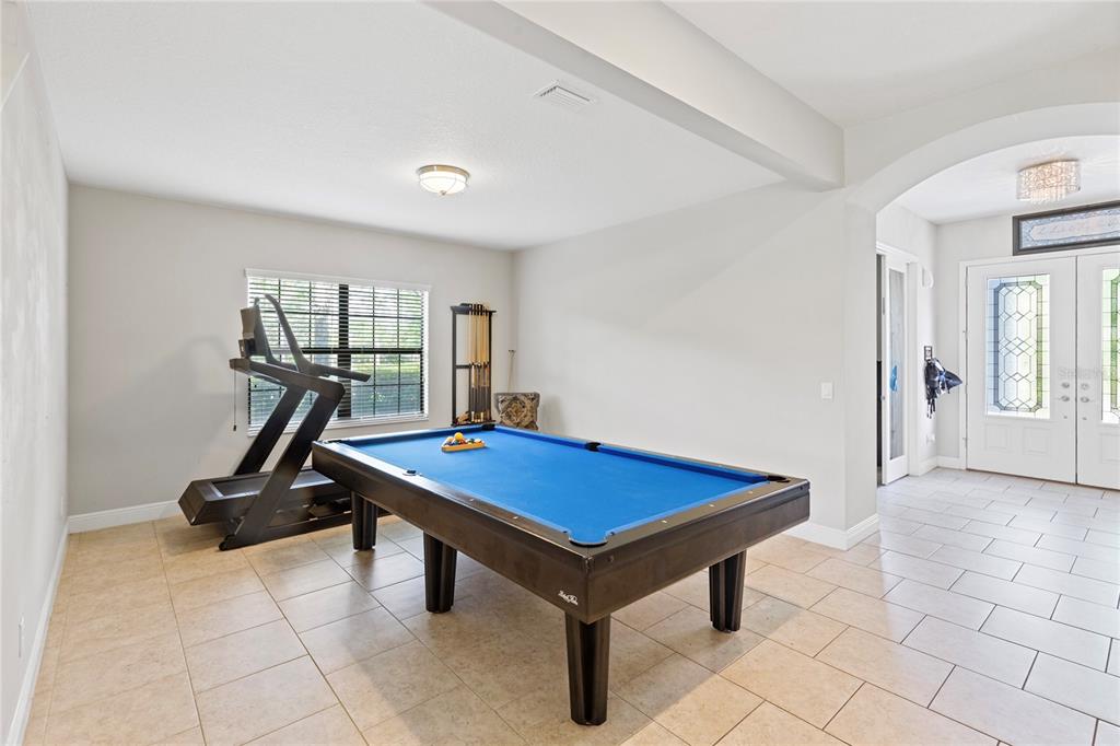 31976 Watoga Loop Wesley Chapel, FL 33543 - Photo 7 of 47 a room with gym equipment and mirrors