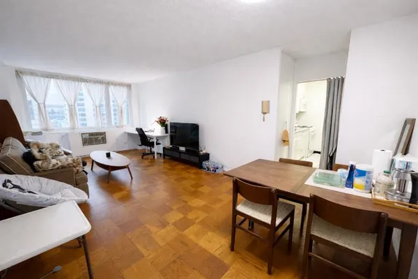 a view of a dining room with furniture and a window