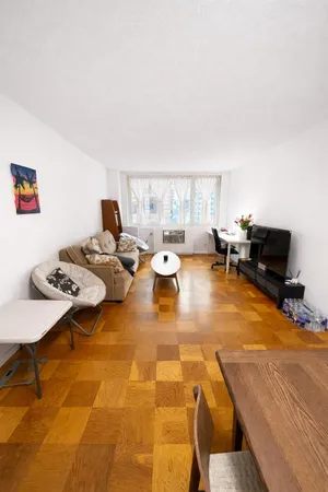 a living room with furniture pool table and a window