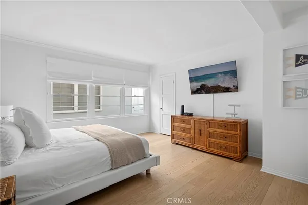 a bedroom with a bed and flat screen tv