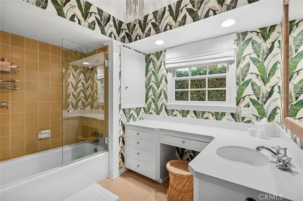 a bathroom with a tub sink and mirror
